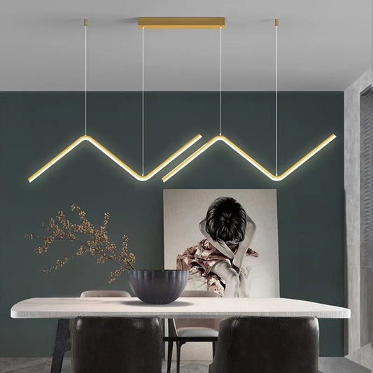suspension luminaire minimaliste or  au dessus d'une table à manger